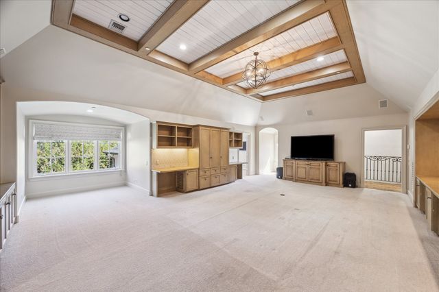 a view of an empty room with a fireplace and a window