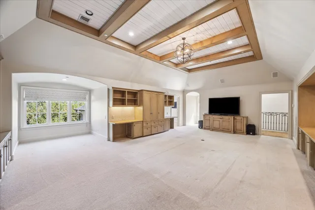 a view of an empty room with a fireplace and a window