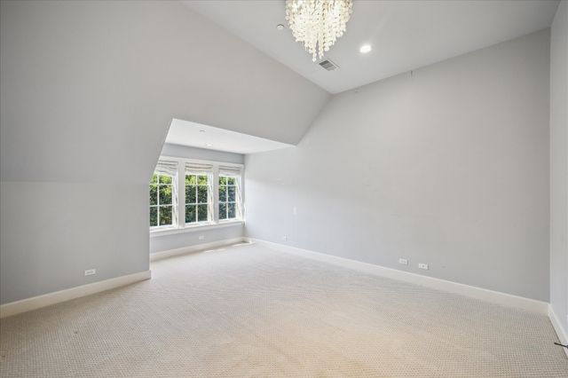 an aerial view of a house with a garden and lake view