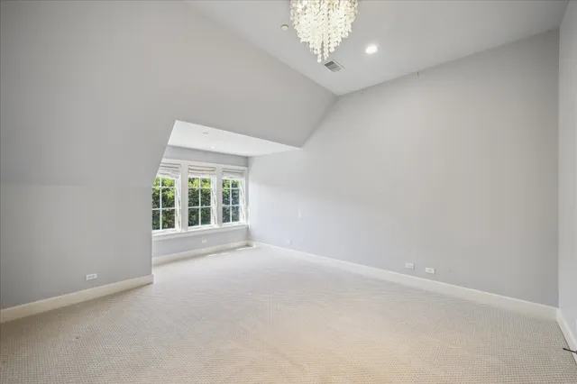 an aerial view of a house with a garden and lake view