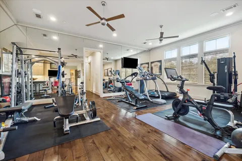 a kitchen that has a microwave a stove a table and chairs in it