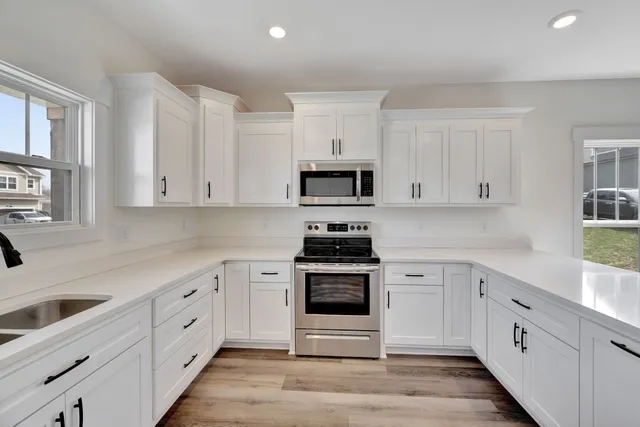 a kitchen with white cabinets and a sink