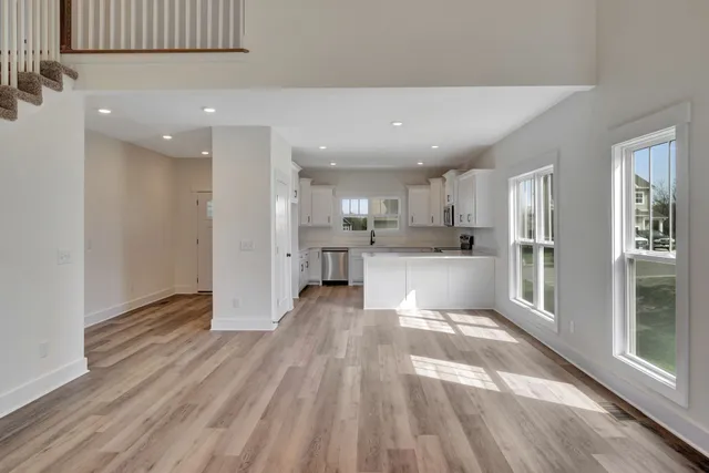 a kitchen with white cabinets appliances and sink