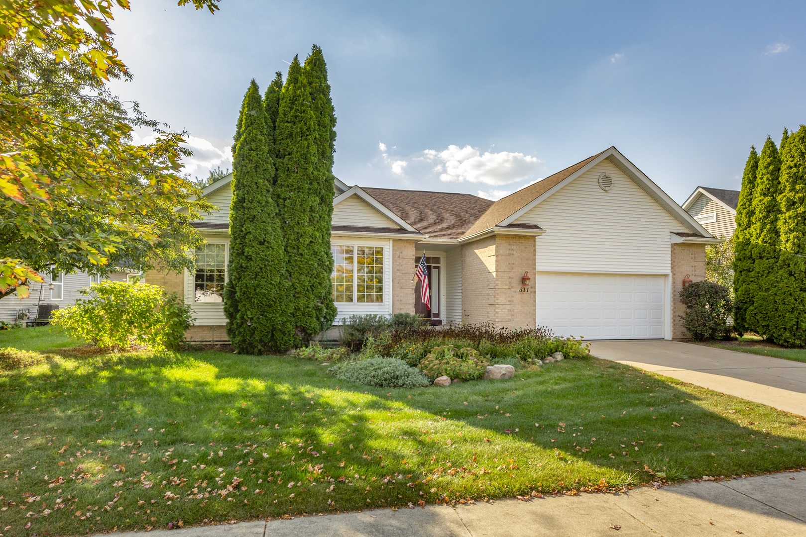 a front view of a house with a yard and garage
