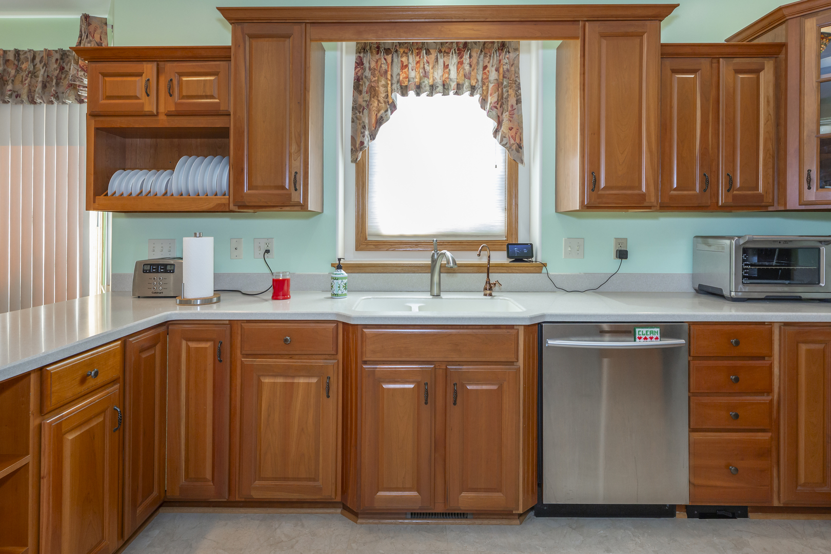 311 Stearn Drive Genoa, IL 60135 - Photo 18 of 48 a kitchen with stainless steel appliances granite countertop a sink and cabinets