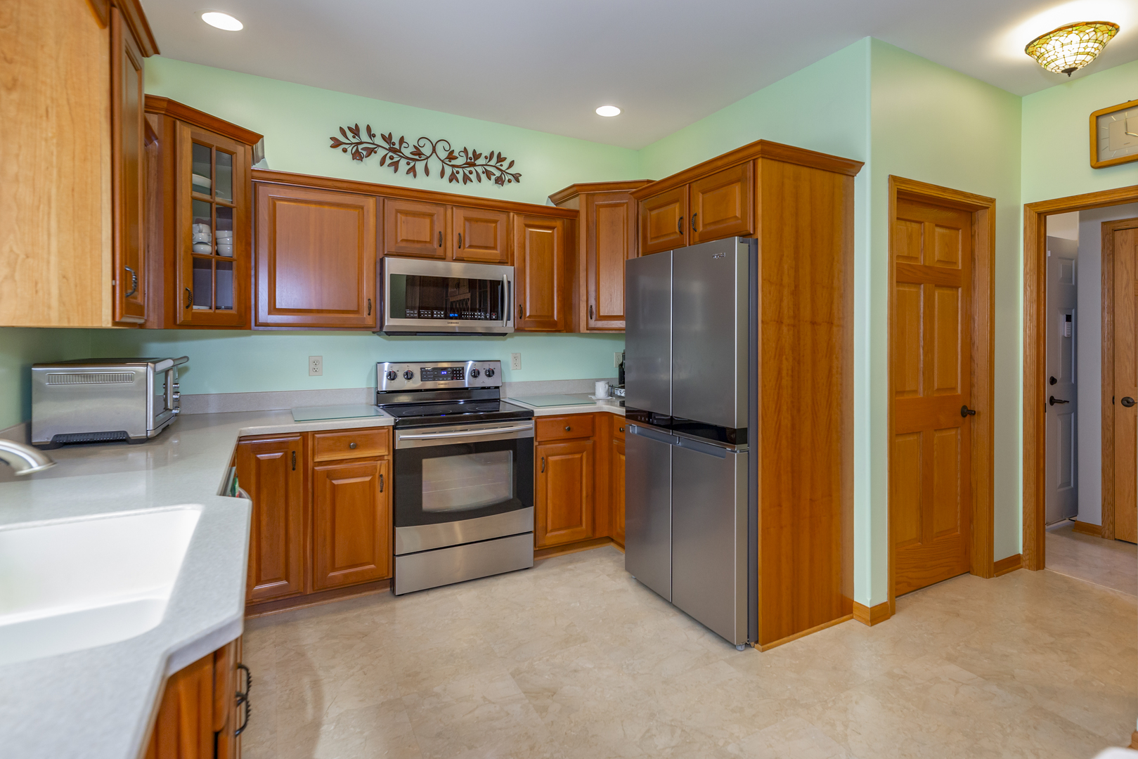 311 Stearn Drive Genoa, IL 60135 - Photo 19 of 48 a kitchen with stainless steel appliances granite countertop a refrigerator and a stove top oven