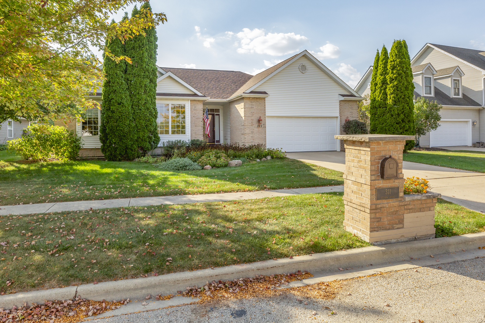 311 Stearn Drive Genoa, IL 60135 - Photo 2 of 48 a front view of a house with garden