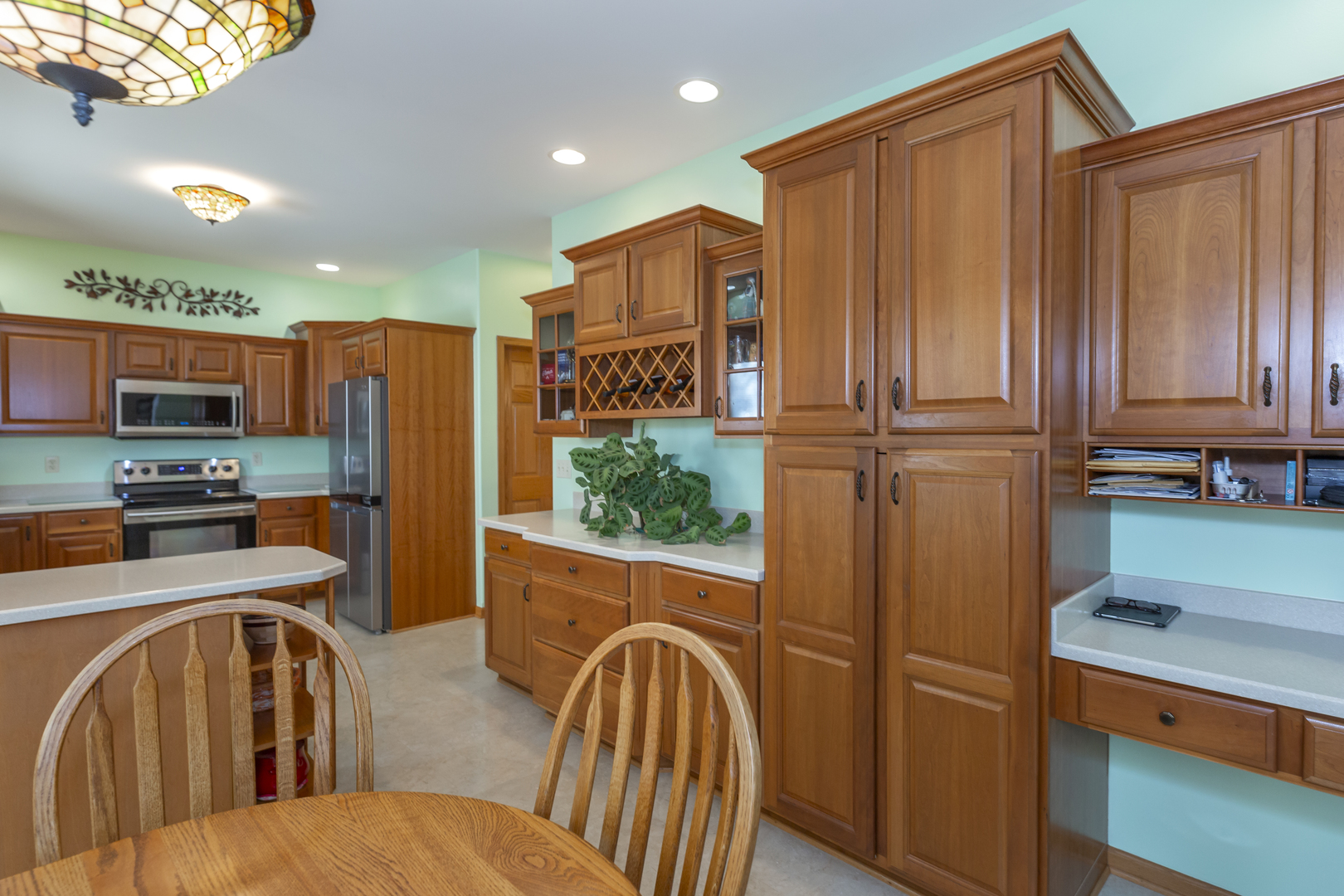 311 Stearn Drive Genoa, IL 60135 - Photo 21 of 48 a open kitchen with stainless steel appliances granite countertop a refrigerator and a stove top oven