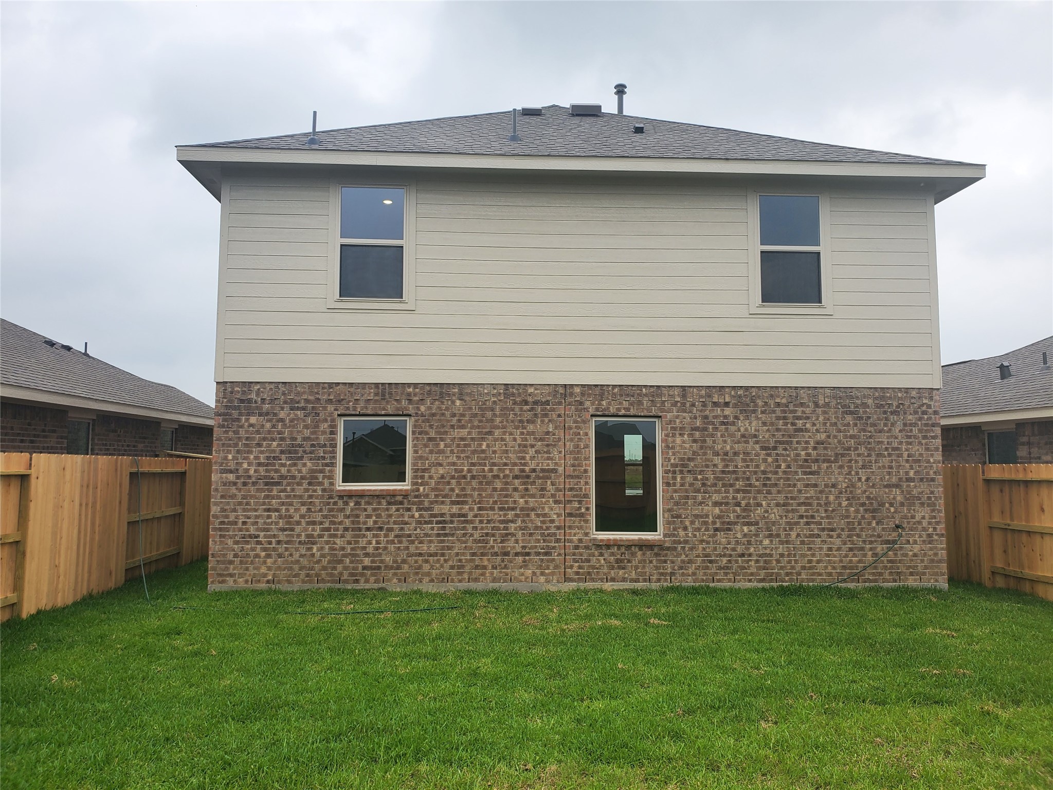 3115 Savannah Rose Drive Angleton, TX 77515 - Photo 20 of 20 a brick house with a small yard