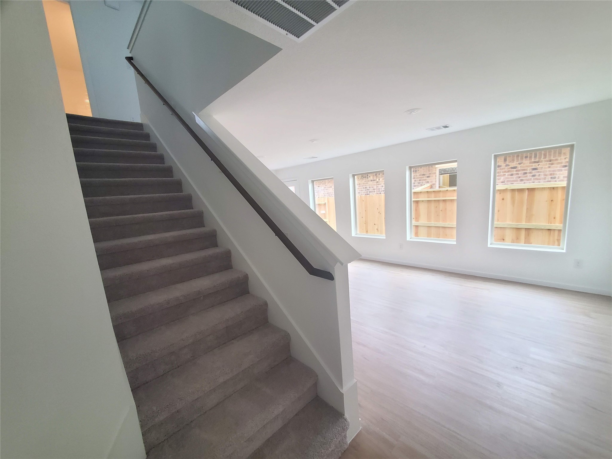 3115 Savannah Rose Drive Angleton, TX 77515 - Photo 5 of 20 a view of an empty room with wooden floor and windows
