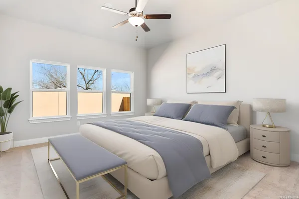 an empty room with a ceiling fan and carpet