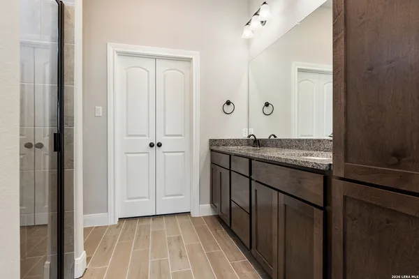 a view of a hallway with wooden floor and closet