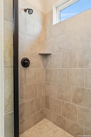 a bathroom with a granite countertop bathtub sink vanity mirror and toilet