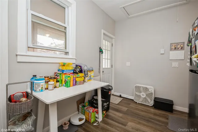 a utility room with toys and wooden floor