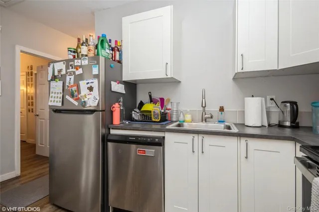 a kitchen with stainless steel appliances granite countertop a refrigerator and a sink