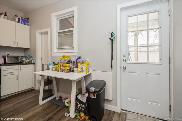 a view of a workspace with furniture and a window