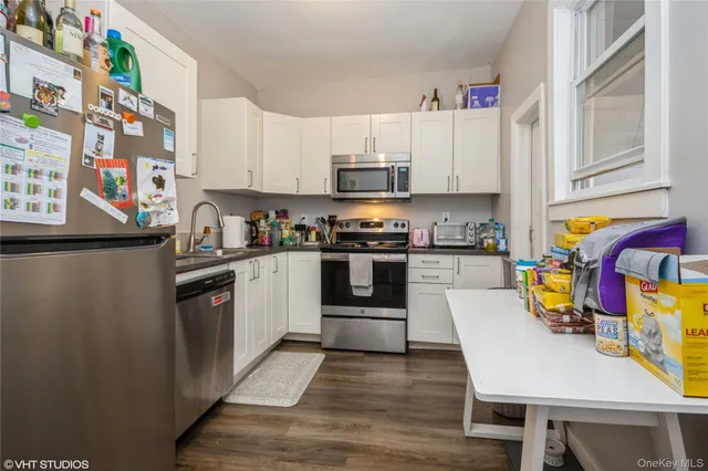 a kitchen with stainless steel appliances a stove a sink and a refrigerator
