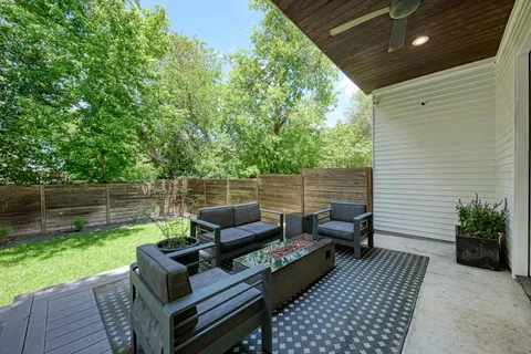 a view of a patio with couches chairs and a yard