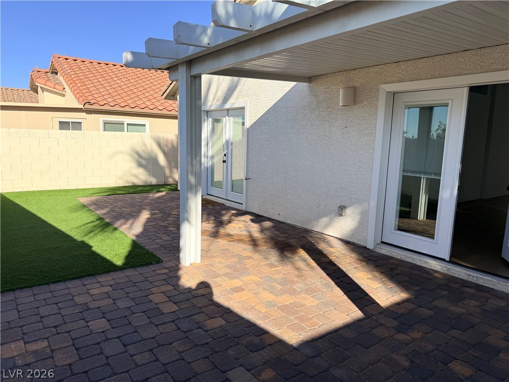 2122 Hidden Ranch Terrace Henderson, NV 89052 - Photo 20 of 20 A spacious brick paver patio extends from the home, framed by artificial turf and a sturdy privacy wall.