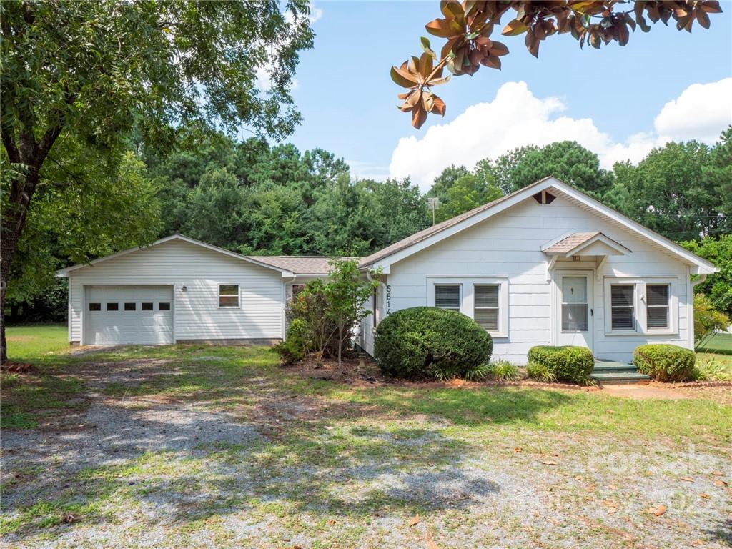 5614 Griffith Road Monroe, NC 28112 - Photo 1 of 28 a view of a house with yard and a garden