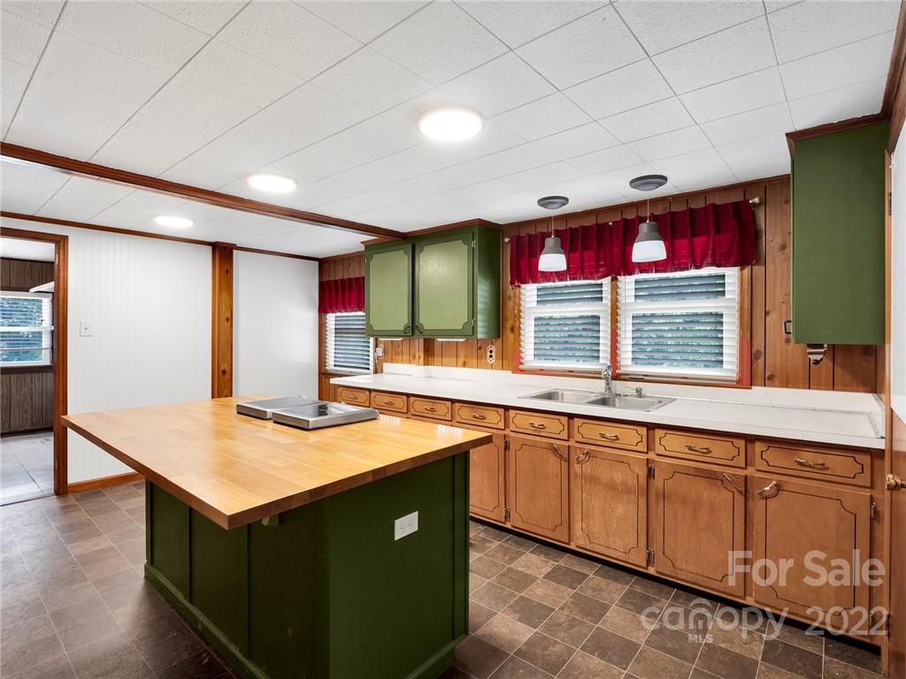 5614 Griffith Road Monroe, NC 28112 - Photo 13 of 28 a kitchen with stainless steel appliances granite countertop a sink counter space cabinets and a large window