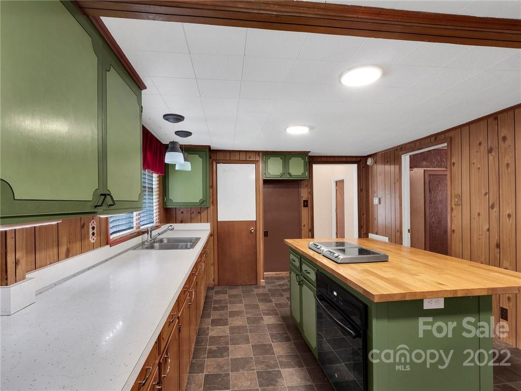 5614 Griffith Road Monroe, NC 28112 - Photo 16 of 28 a kitchen with kitchen island granite countertop a sink and a stove