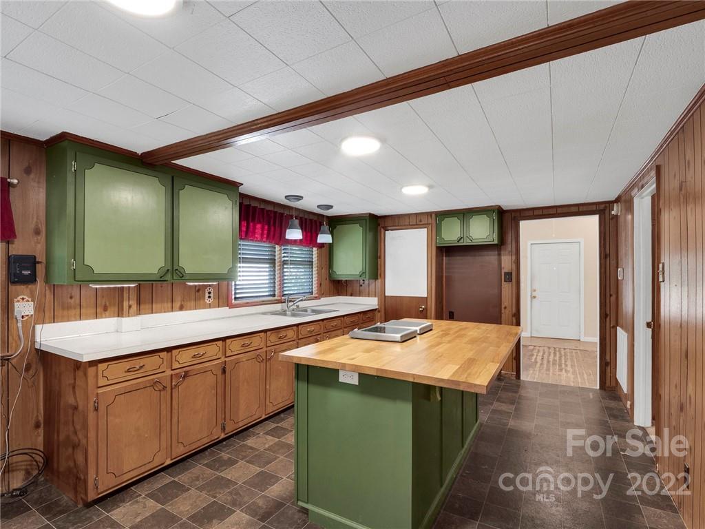 5614 Griffith Road Monroe, NC 28112 - Photo 17 of 28 a kitchen with kitchen island a sink stove and refrigerator