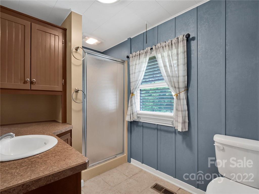 5614 Griffith Road Monroe, NC 28112 - Photo 27 of 28 a bathroom with a granite countertop sink toilet and shower