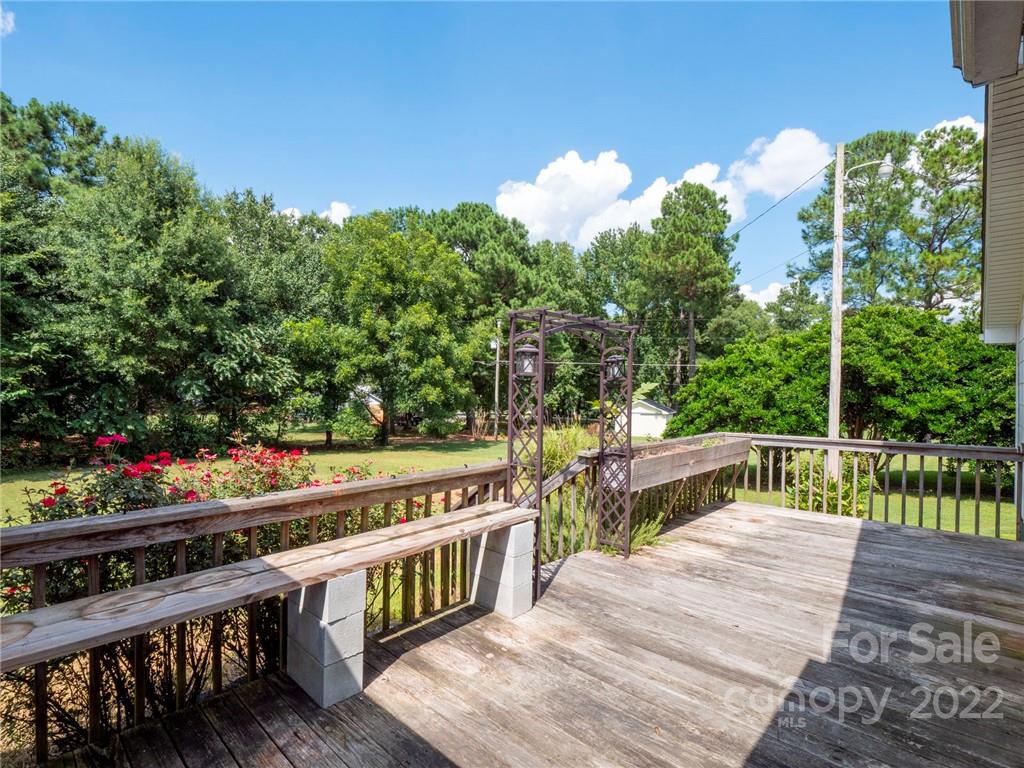 5614 Griffith Road Monroe, NC 28112 - Photo 3 of 28 a balcony with two plants and wooden fence