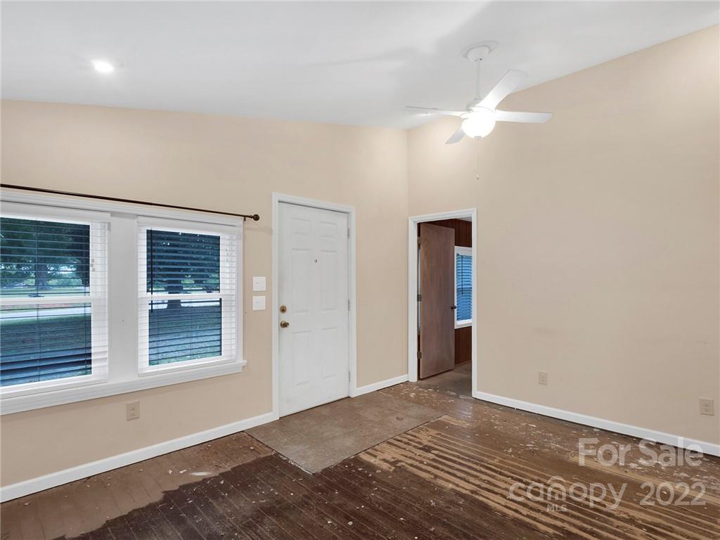 5614 Griffith Road Monroe, NC 28112 - Photo 8 of 28 a view of an empty room with window and wooden floor