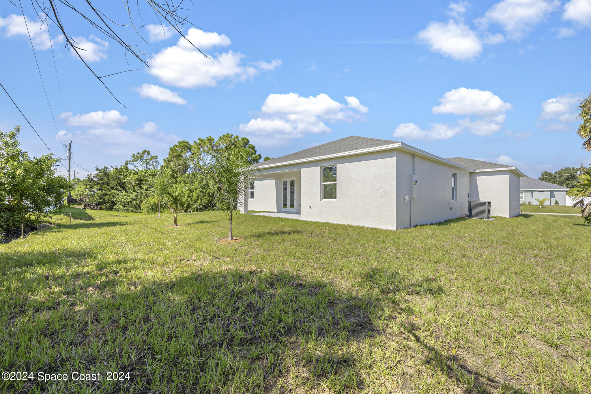 1368 Rabbit Street Southeast Palm Bay, FL 32909 - Photo 29 of 31 a view of a house with backyard and a tree