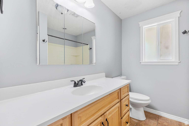 415 East 1150th Street North Logan, UT 84341 - Photo 14 of 38 Bathroom featuring a light wood-finish vanity with a white countertop and integrated sink
