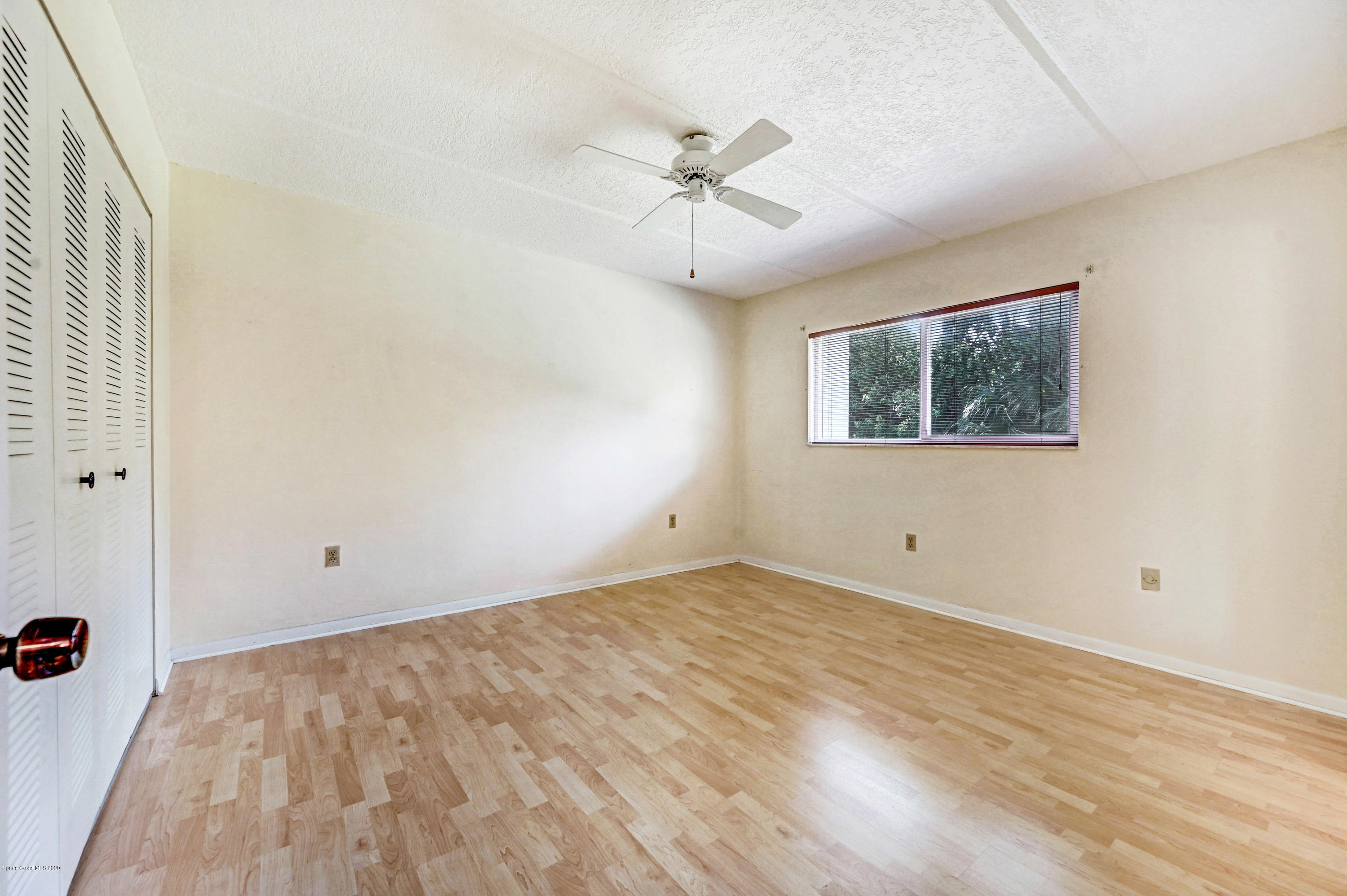 708 Ridge Club Drive, Unit 37 Melbourne, FL 32934 - Photo 12 of 25 an empty room with a window and a ceiling fan