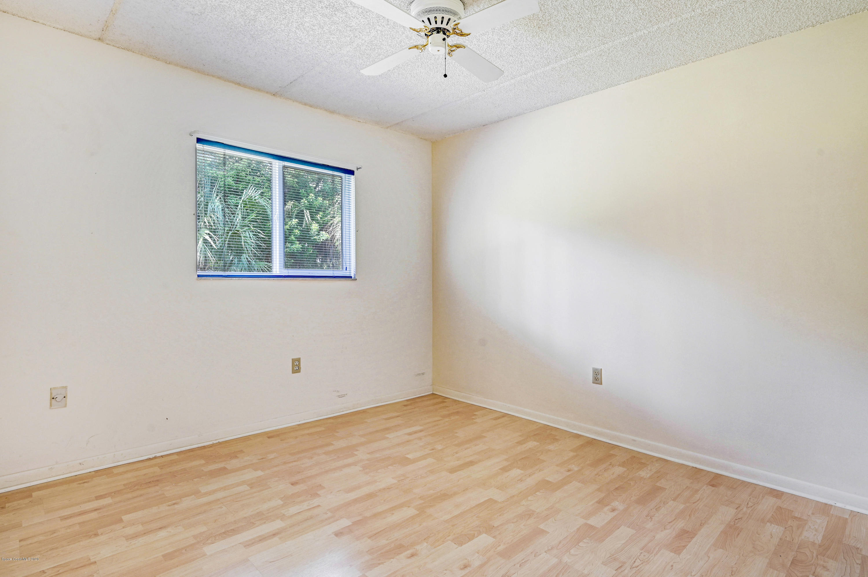 708 Ridge Club Drive, Unit 37 Melbourne, FL 32934 - Photo 15 of 25 an empty room with a window and a ceiling fan