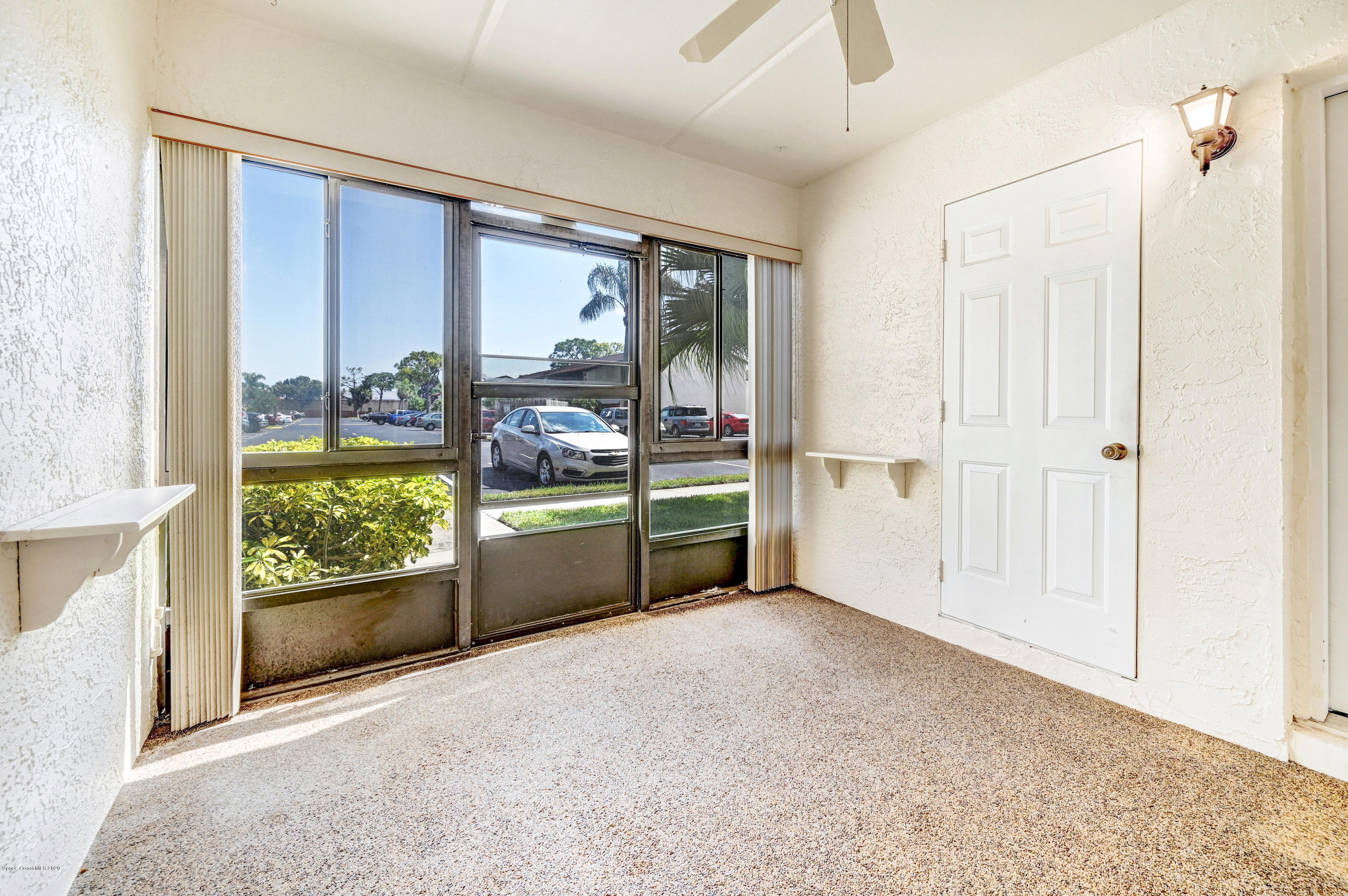 708 Ridge Club Drive, Unit 37 Melbourne, FL 32934 - Photo 3 of 25 an empty room with wooden floor and windows