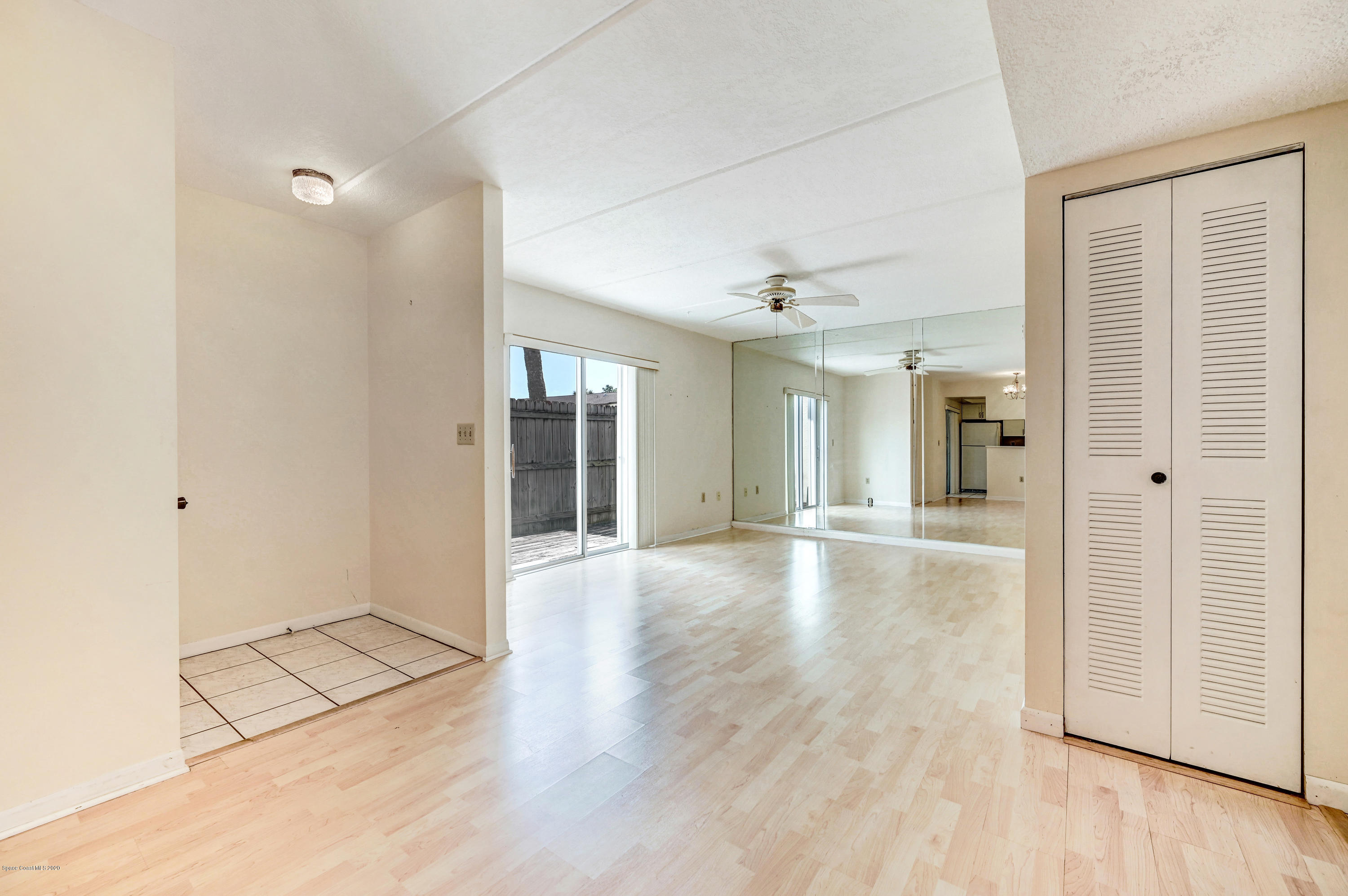 708 Ridge Club Drive, Unit 37 Melbourne, FL 32934 - Photo 4 of 25 an empty room with wooden floor and windows