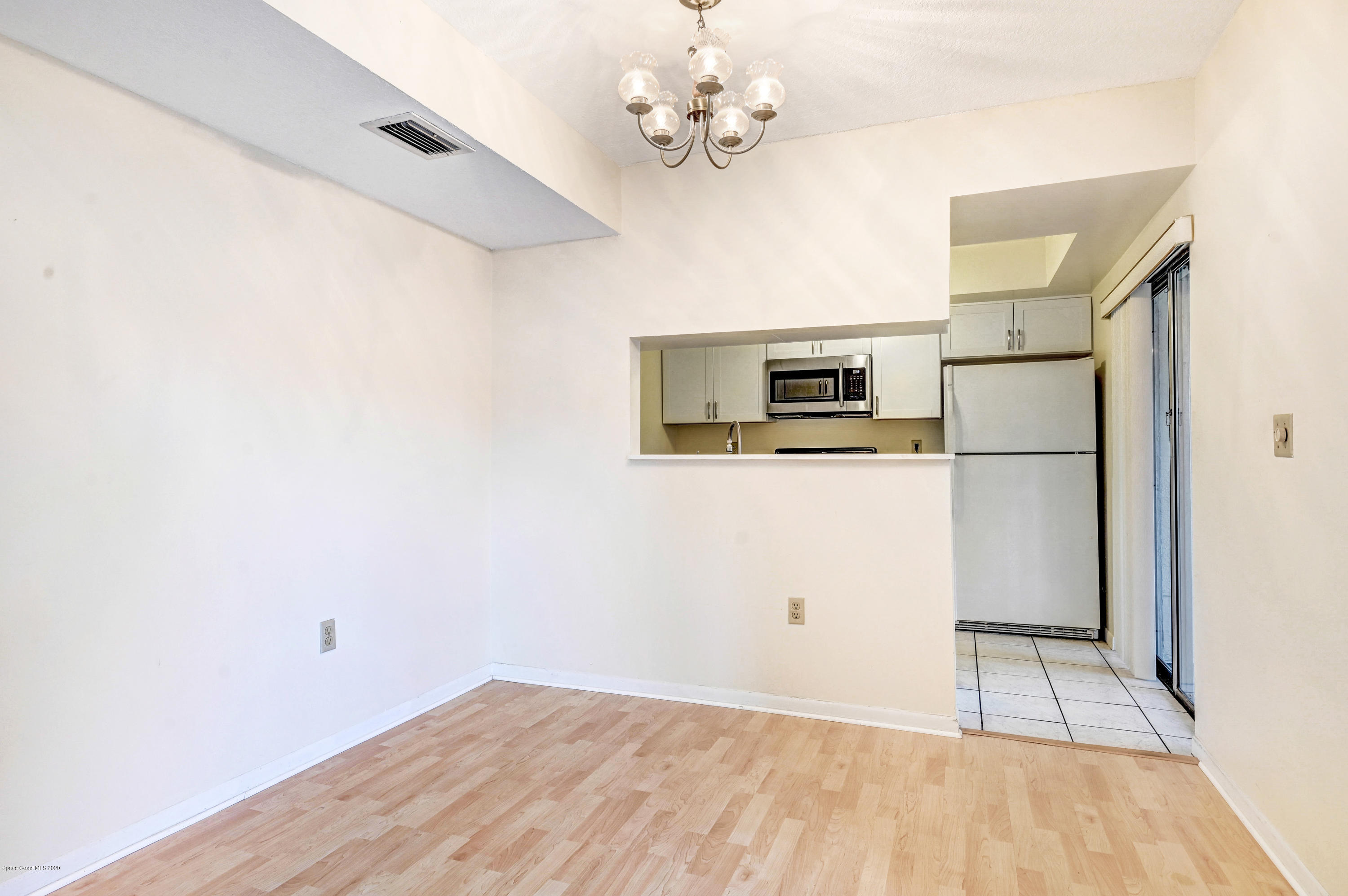 708 Ridge Club Drive, Unit 37 Melbourne, FL 32934 - Photo 7 of 25 a view of a kitchen with wooden floor and a ceiling fan