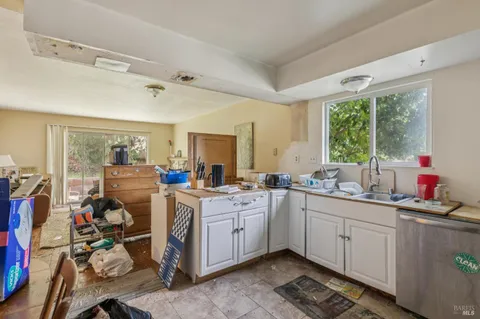 a kitchen that has a lot of cabinets a sink and a stove in it