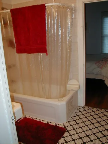 a bathroom with a bathtub and shower