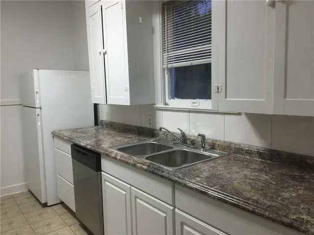 a kitchen with a sink and cabinets