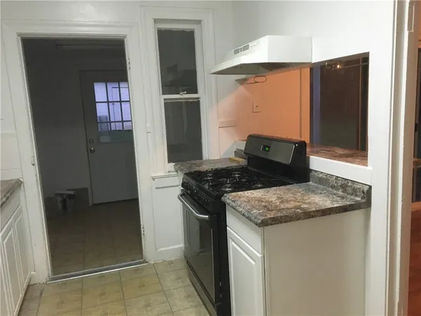 a kitchen with stainless steel appliances granite countertop a refrigerator and a stove