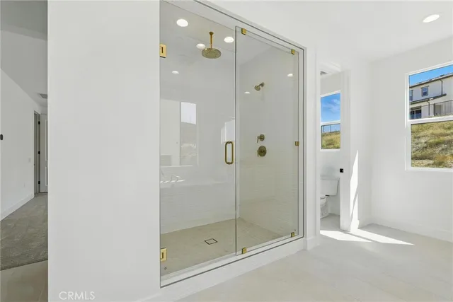 a bathroom with a bathtub shower sink and mirror