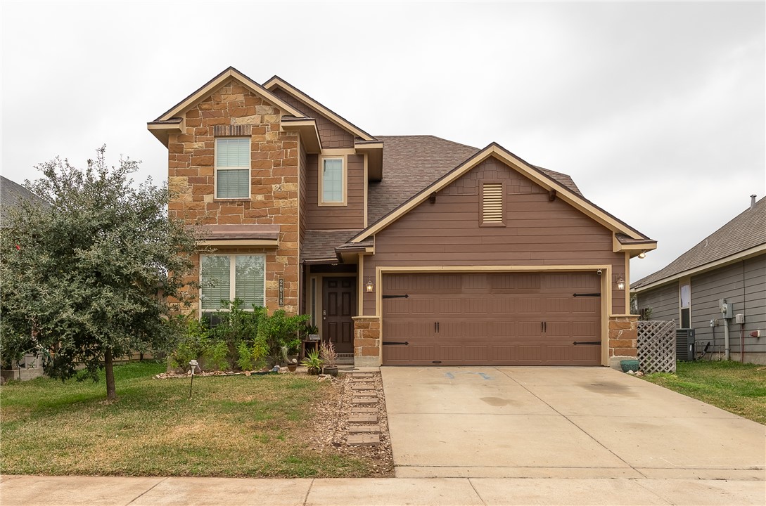 2018 Stubbs Drive Bryan, TX 77807 - Photo 1 of 41 Craftsman-style home with stone siding, a front lawn, driveway, and an attached garage