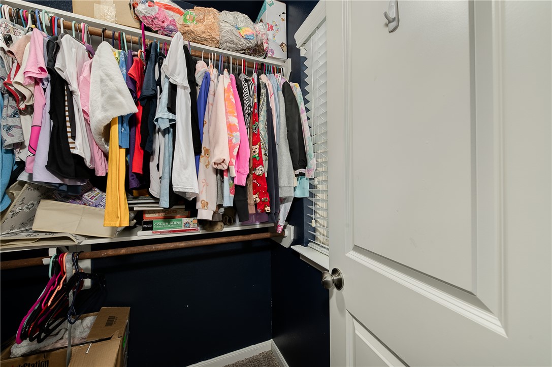 2018 Stubbs Drive Bryan, TX 77807 - Photo 36 of 41 a view of walk in closet with clothes