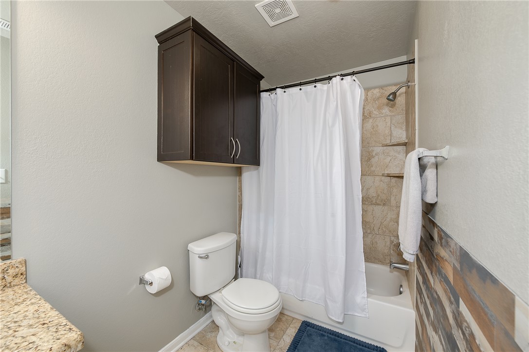 2018 Stubbs Drive Bryan, TX 77807 - Photo 38 of 41 a bathroom with a shower and a toilet