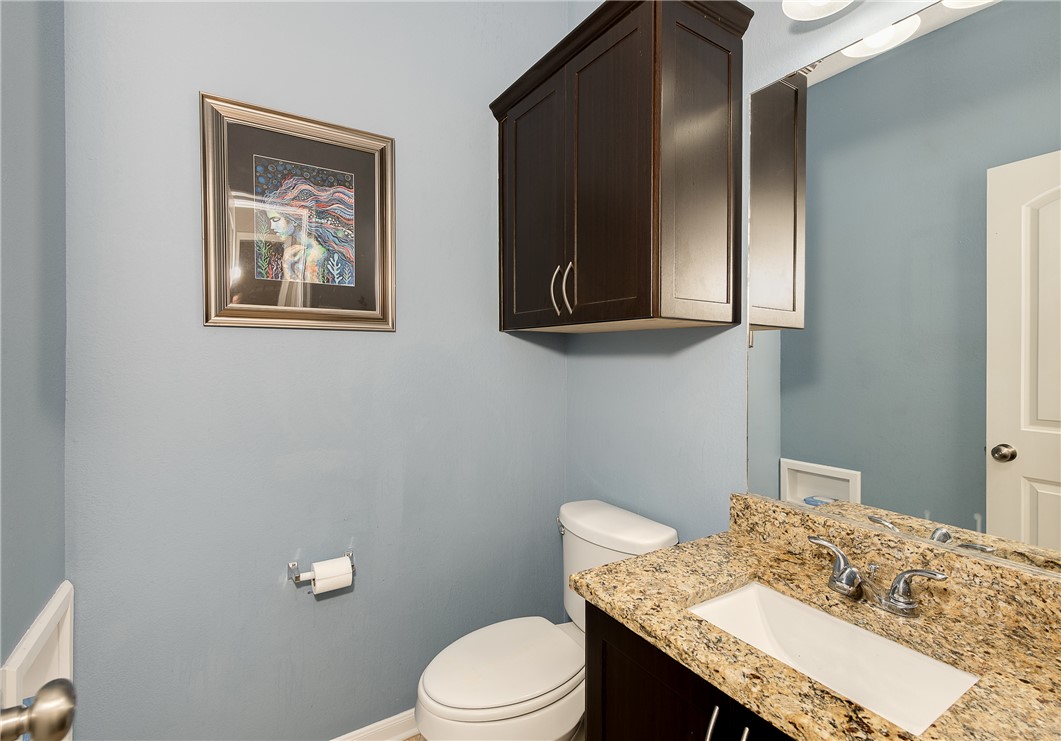 2018 Stubbs Drive Bryan, TX 77807 - Photo 8 of 41 a bathroom with a granite countertop toilet sink and mirror