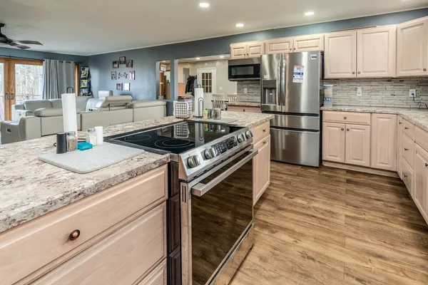 a kitchen with a sink stove and refrigerator