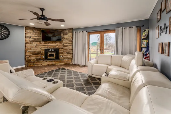 a living room with furniture a fireplace and a large window