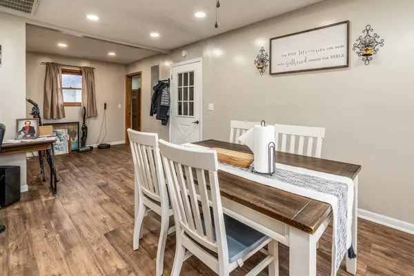 a view of a dining room with furniture and wooden floor