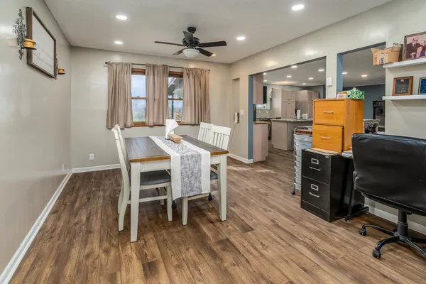 a dining room with furniture and wooden floor